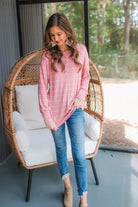 lightweight horizontal striped top with long sleeves, a crew neckline, and a slouched silhouette that ends in a rounded hemline on a solid mauve base