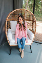 lightweight horizontal striped top with long sleeves, a crew neckline, and a slouched silhouette that ends in a rounded hemline on a solid mauve base