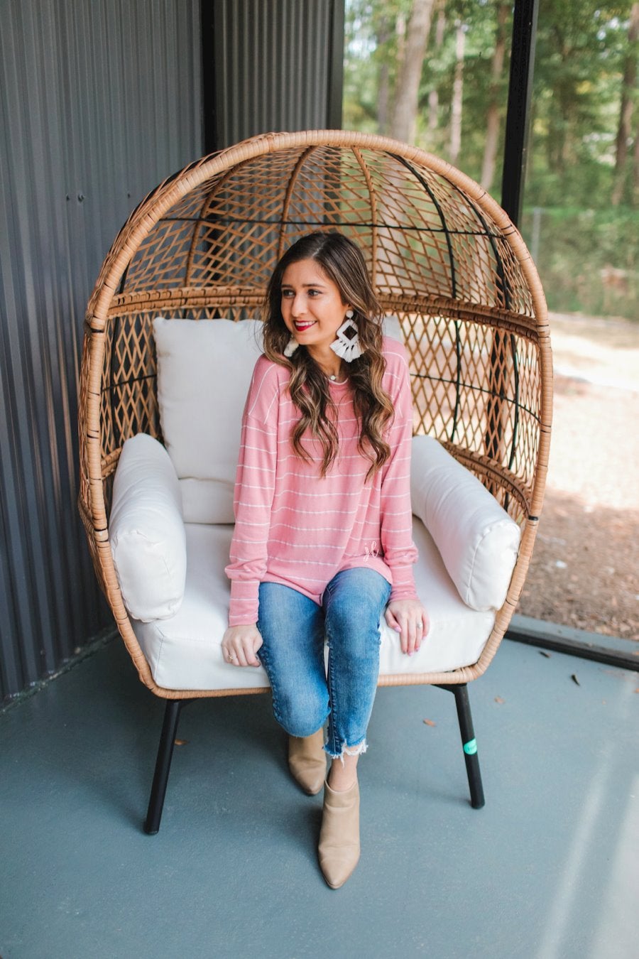 lightweight horizontal striped top with long sleeves, a crew neckline, and a slouched silhouette that ends in a rounded hemline on a solid mauve base