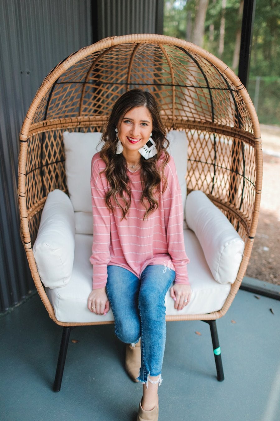 lightweight horizontal striped top with long sleeves, a crew neckline, and a slouched silhouette that ends in a rounded hemline on a solid mauve base