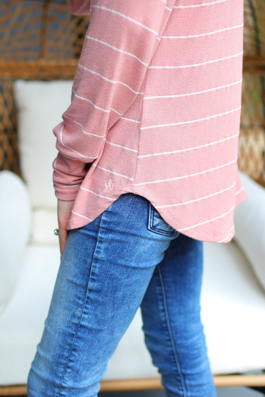 lightweight horizontal striped top with long sleeves, a crew neckline, and a slouched silhouette that ends in a rounded hemline on a solid mauve base