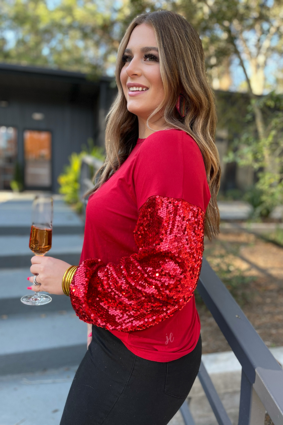 balloon long sleeves with a drop shoulder adorned with sequin accents, a round neckline, and cuffs