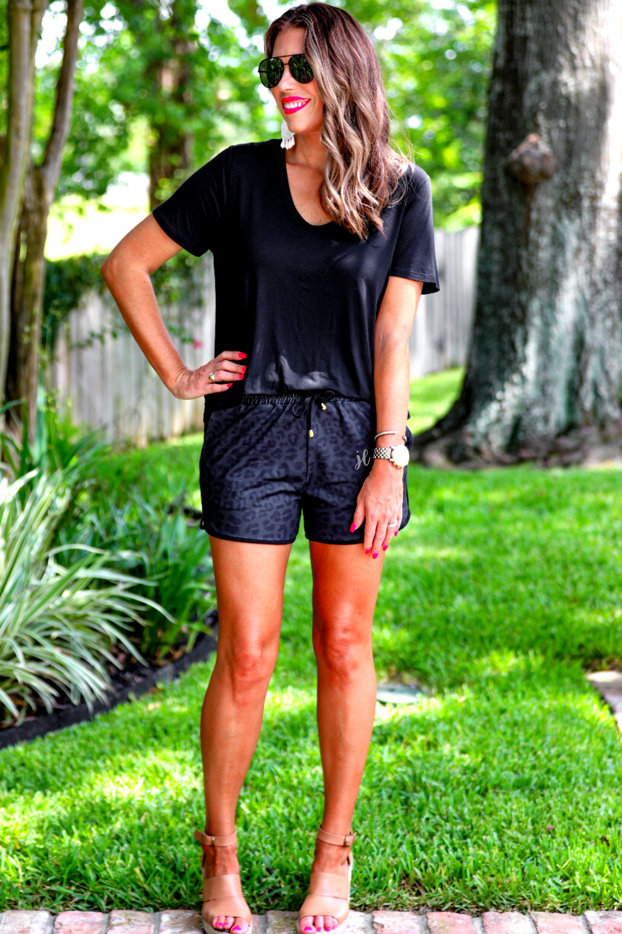 mid-rise, tie waist drawstring, side pocks, and relaxed fit on a black leopard print on black fabric