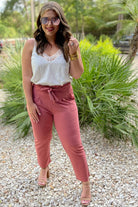 high-waisted paper-bag silhouette pants with a ruffle trim and sash tie, lightweight drapey fabric, straight legs, side pockets polished with a flirty ruffle, and unlined for breezy comfort in rose