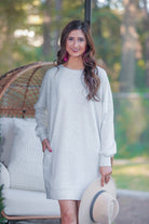 extended long-sleeve dress with a round neckline and functional side pockets made of soft sweatshirt fabric in heathered grey