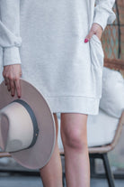 extended long-sleeve dress with a round neckline and functional side pockets made of soft sweatshirt fabric in heathered grey