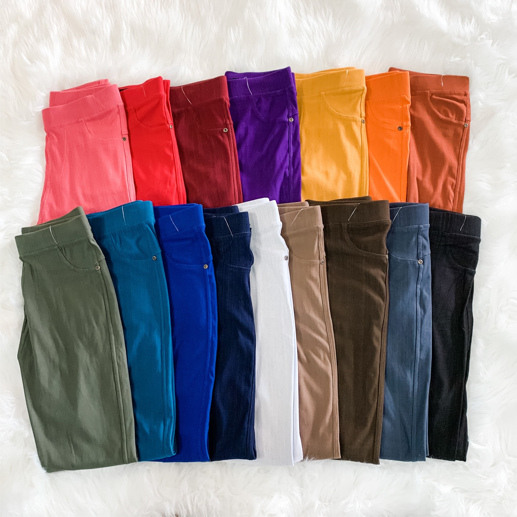 solid pull-on style leggings made of premium stretch fabric thicker than regular leggings, an elastic waistband, double back pockets, and a unique stripe detailing on the inside in coral, red, burgundy, purple, mustard, orange, rust, olive, teal, royal blue, navy, white, mocha, brown, charcoal, and black
