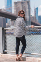 long sleeve drop shoulder shacket with button closures, a button-down front, a collared neckline, chest pockets, and back detailing on a black and white houndstooth print