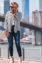 long sleeve drop shoulder shacket with button closures, a button-down front, a collared neckline, chest pockets, and back detailing on a black and white houndstooth print