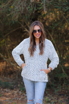 a long-sleeve fluffy pullover with a quarter zip, convenient front pockets, a foldable collar, and lining on ivory with a navy background and diamond snake pattern print shearling material that runs oversized