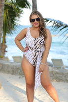 a one-piece swimsuit made of stretchy material with a scoop back, chunky straps, a versatile accent tie, and removable padding on a neutral color block animal print pattern fabric