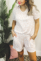 a neutral taupe animal print lounge set crafted from soft stretch fabric with a short-sleeve V-neck top, matching pull-on shorts, elastic waistband, side pockets, and relaxed fit