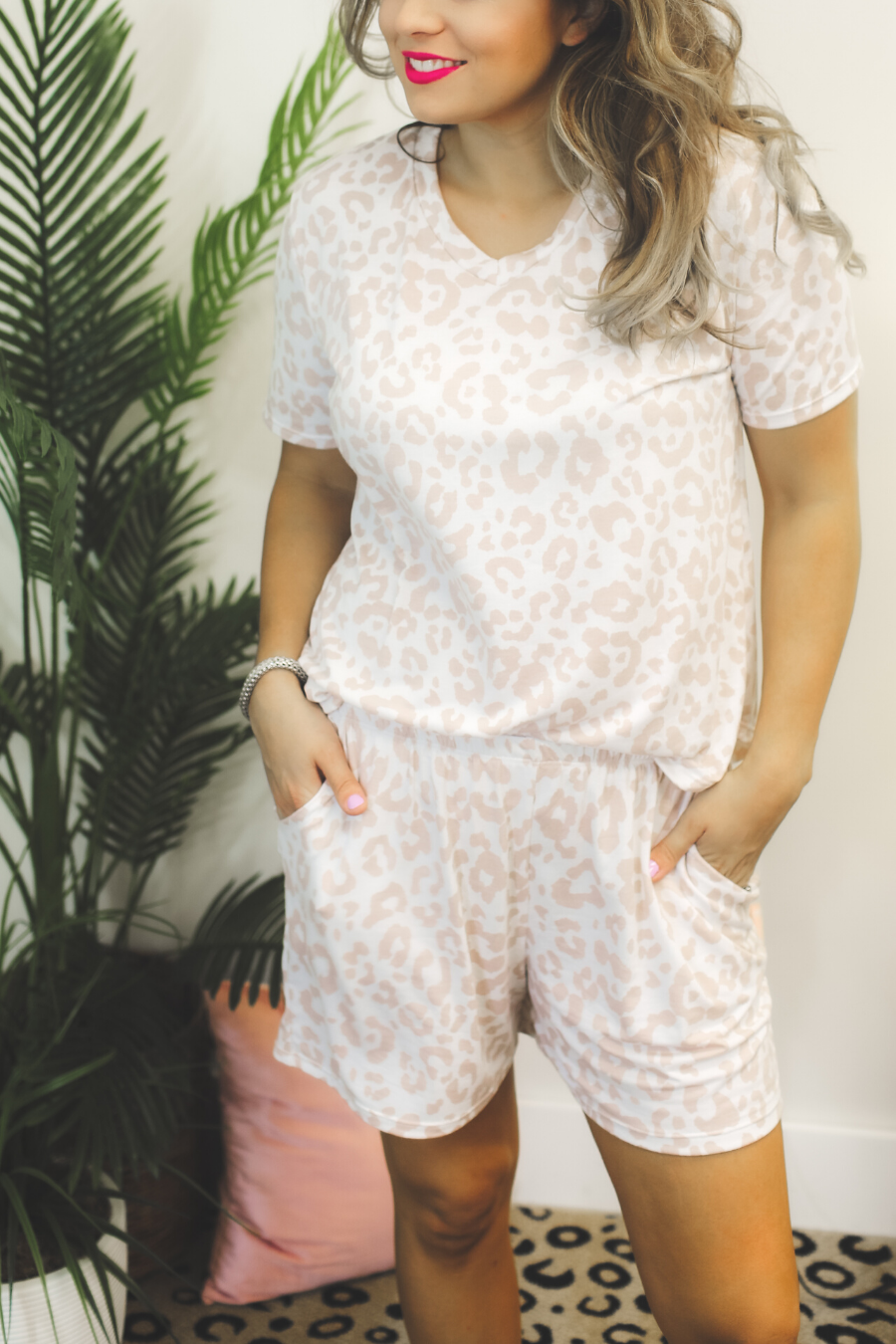 a neutral taupe animal print lounge set crafted from soft stretch fabric with a short-sleeve V-neck top, matching pull-on shorts, elastic waistband, side pockets, and relaxed fit