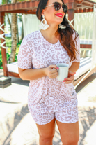 a neutral taupe animal print lounge set crafted from soft stretch fabric with a short-sleeve V-neck top, matching pull-on shorts, elastic waistband, side pockets, and relaxed fit