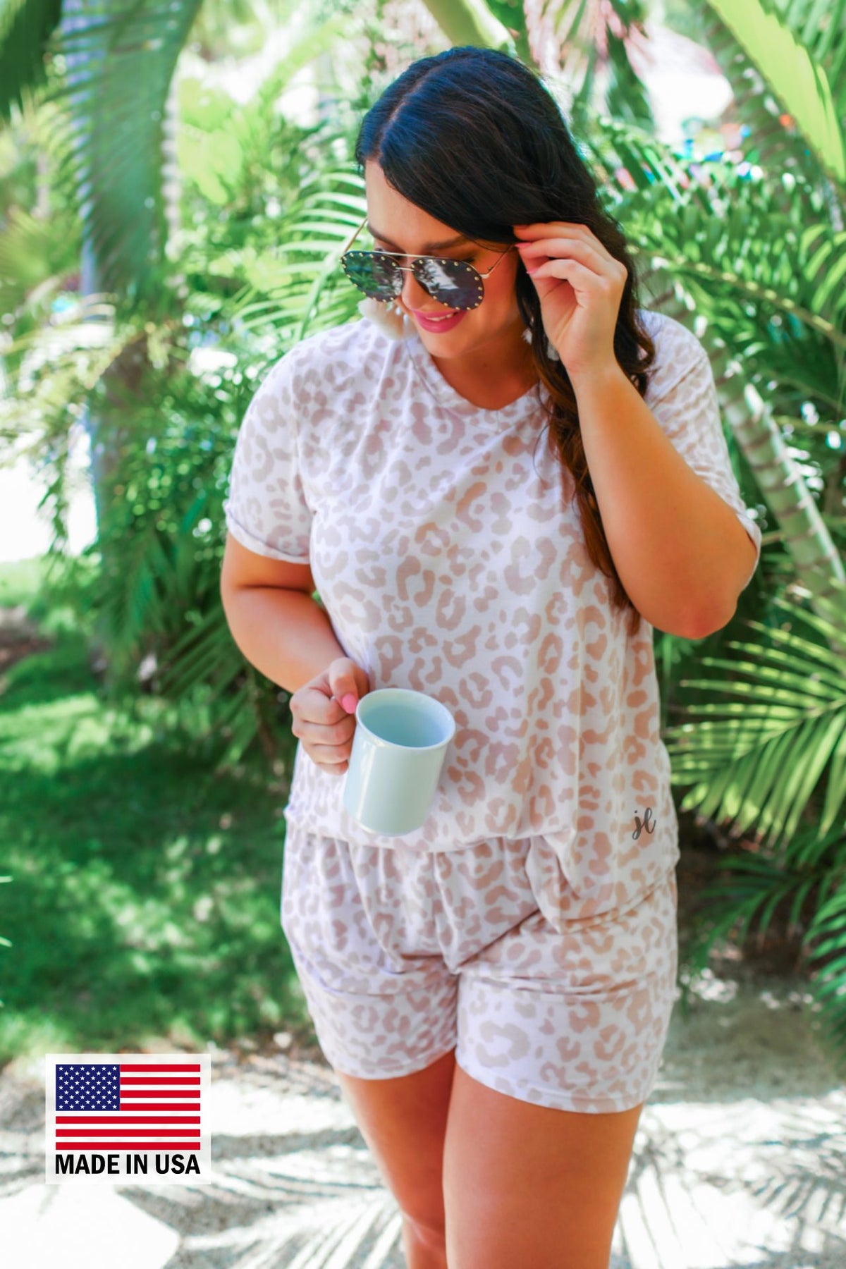 a neutral taupe animal print lounge set crafted from soft stretch fabric with a short-sleeve V-neck top, matching pull-on shorts, elastic waistband, side pockets, and relaxed fit, accented with a MADE IN USA watermark in the bottom left-hand corner