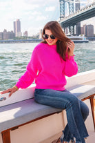 a pink long sleeve sweater with a drop-shoulder for a relaxed fit, a crew neckline, and a ribbed hemline on a textured ultra-soft design fabric