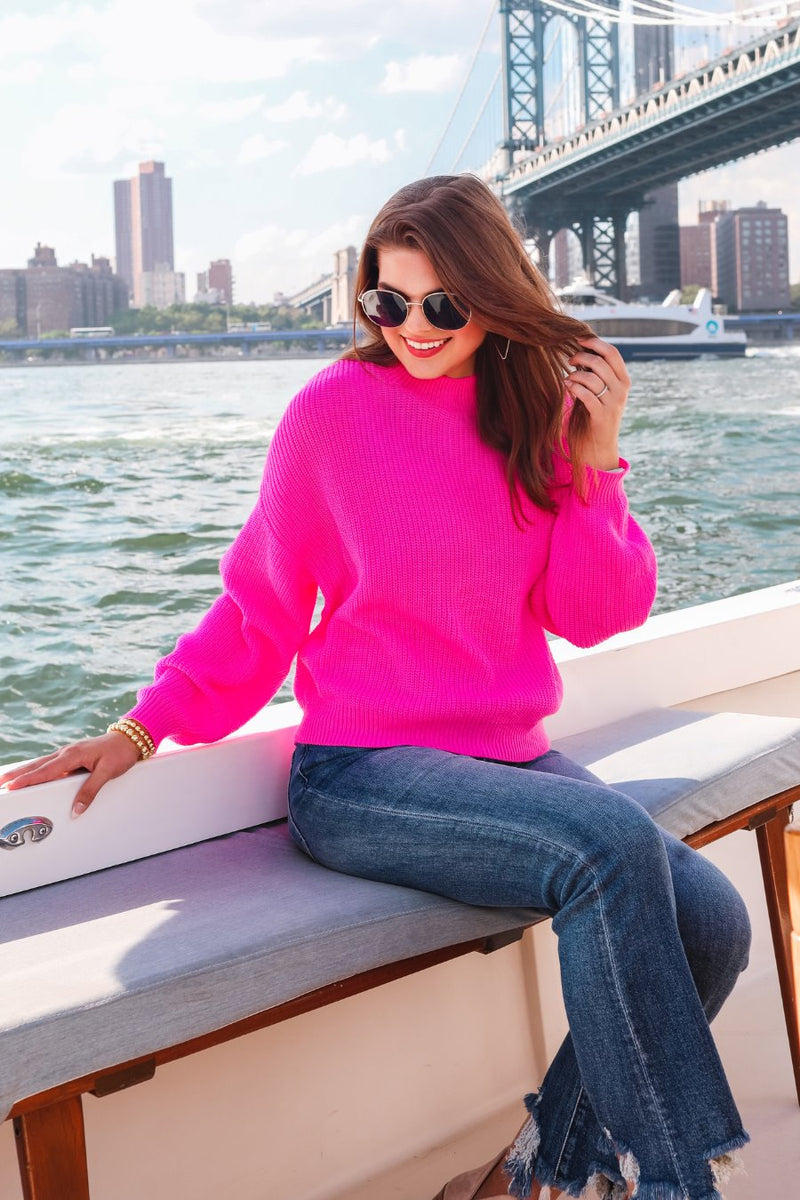 a pink long sleeve sweater with a drop-shoulder for a relaxed fit, a crew neckline, and a ribbed hemline on a textured ultra-soft design fabric