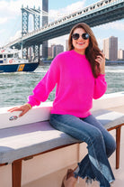 a pink long sleeve sweater with a drop-shoulder for a relaxed fit, a crew neckline, and a ribbed hemline on a textured ultra-soft design fabric