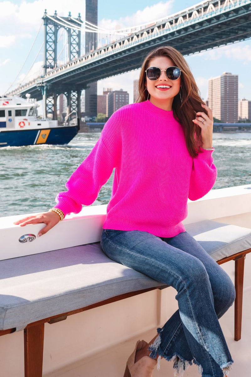 a pink long sleeve sweater with a drop-shoulder for a relaxed fit, a crew neckline, and a ribbed hemline on a textured ultra-soft design fabric