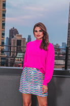 a pink long sleeve sweater with a drop-shoulder for a relaxed fit, a crew neckline, and a ribbed hemline on a textured ultra-soft design fabric
