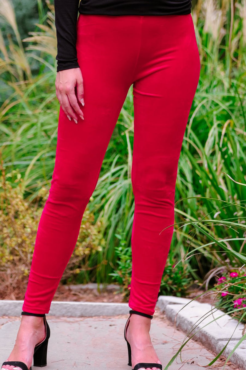 ultra soft stretch leggings crafted from luxurious velvet fabric with an elastic waistband and flattering rise in red