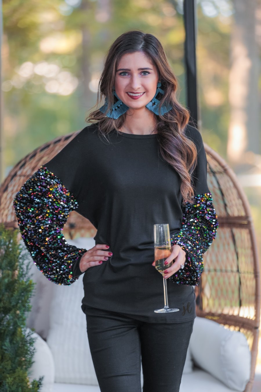 solid black top with long balloon sleeves adorned with multicolor sequins