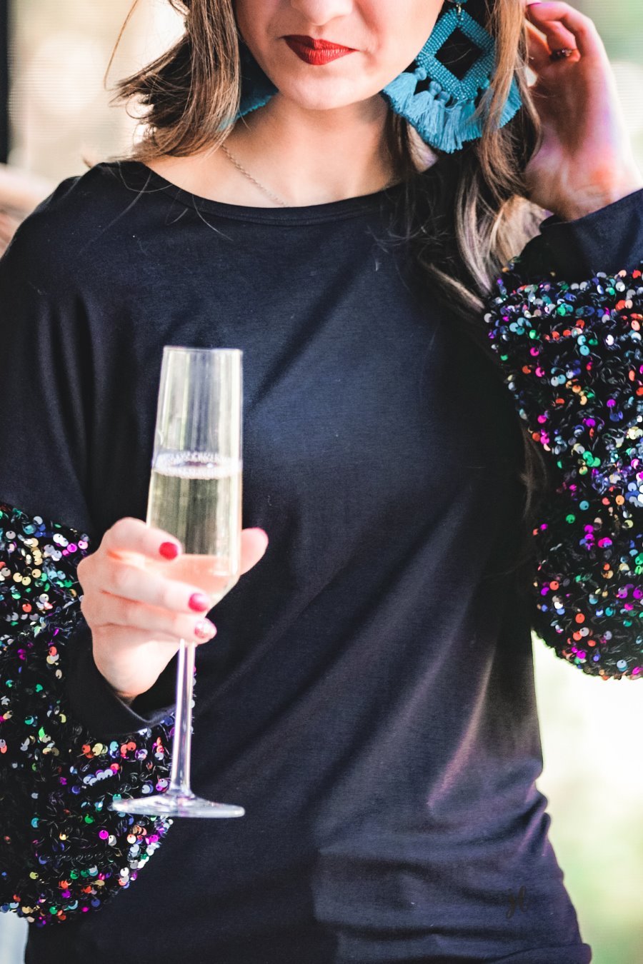 solid black top with long balloon sleeves adorned with multicolor sequins