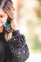 solid black top with long balloon sleeves adorned with multicolor sequins