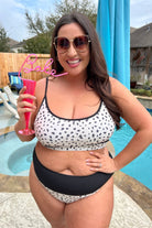 two-piece swimsuit made of lightweight four-way stretchy material and subtle ribbed texturing on a neutral leopard print with a bralette-style top, adjustable spaghetti straps, removable padding, a black band, and flattering form-fitting silhouette paired with high waistline bottoms with a black solid band for added tummy control