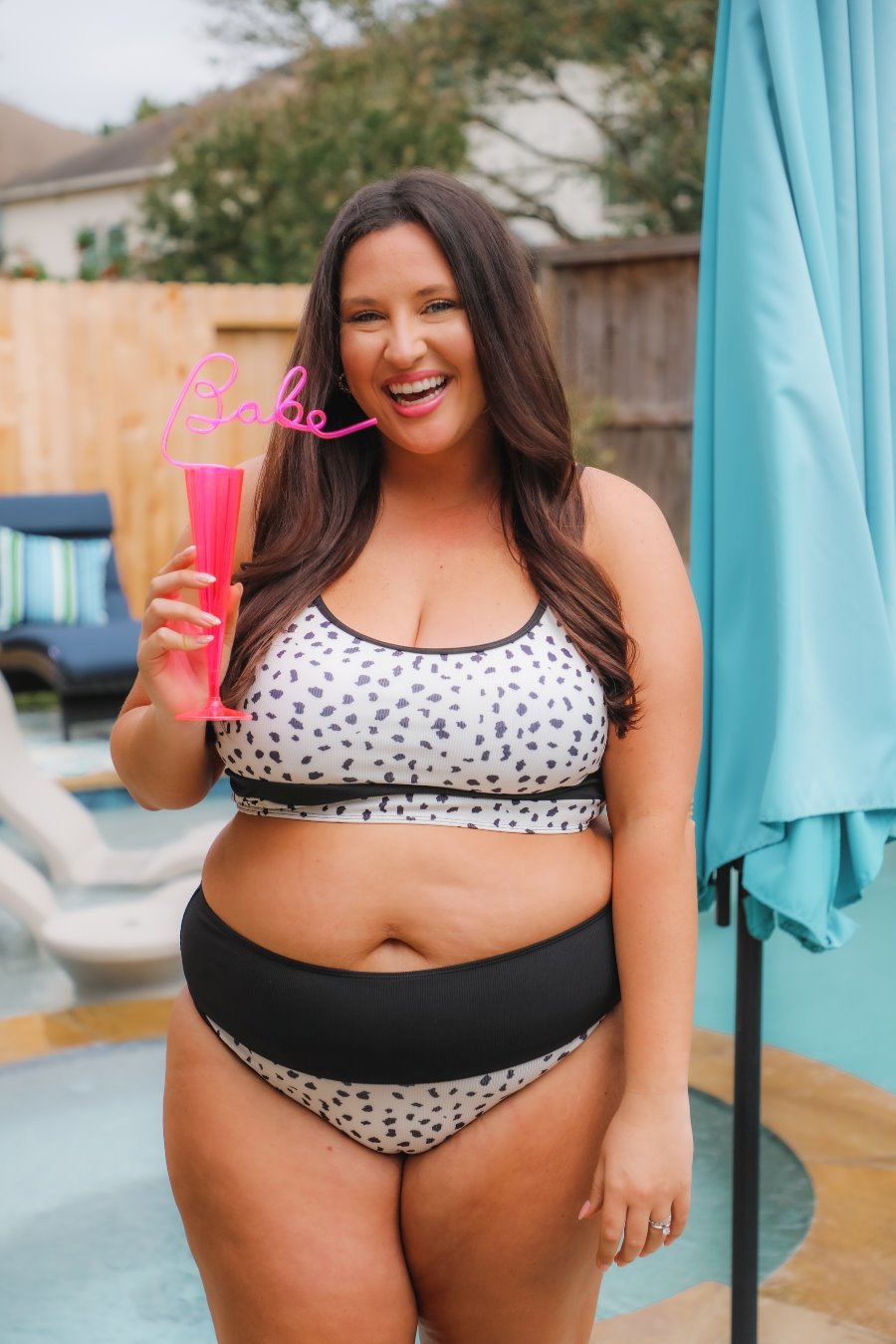 two-piece swimsuit made of lightweight four-way stretchy material and subtle ribbed texturing on a neutral leopard print with a bralette-style top, adjustable spaghetti straps, removable padding, a black band, and flattering form-fitting silhouette paired with high waistline bottoms with a black solid band for added tummy control